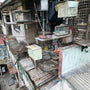 Slums Corner Building with Caged Parrots